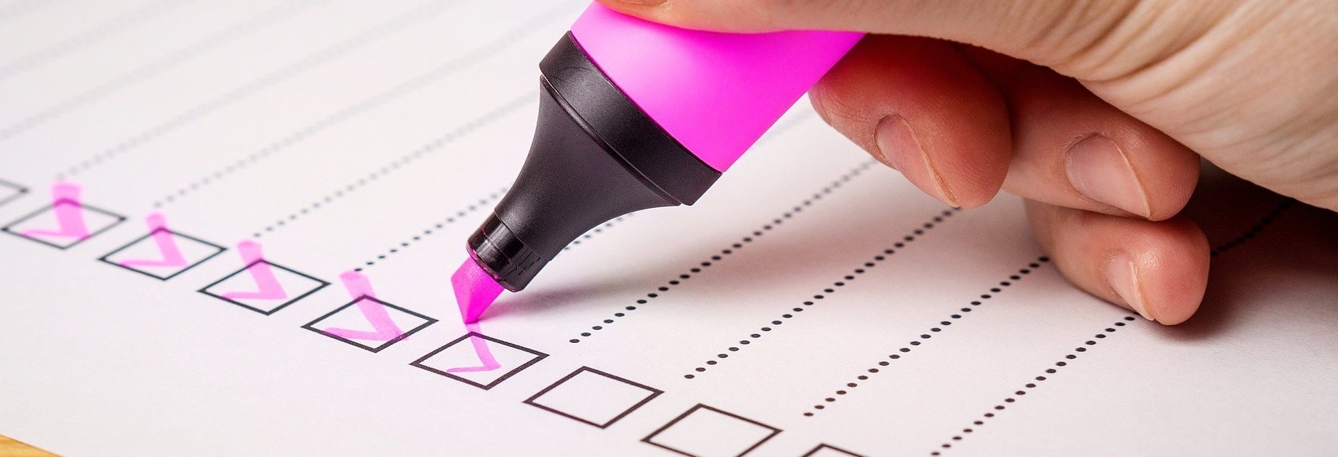 Highlighter pen ticking off items on a checklist