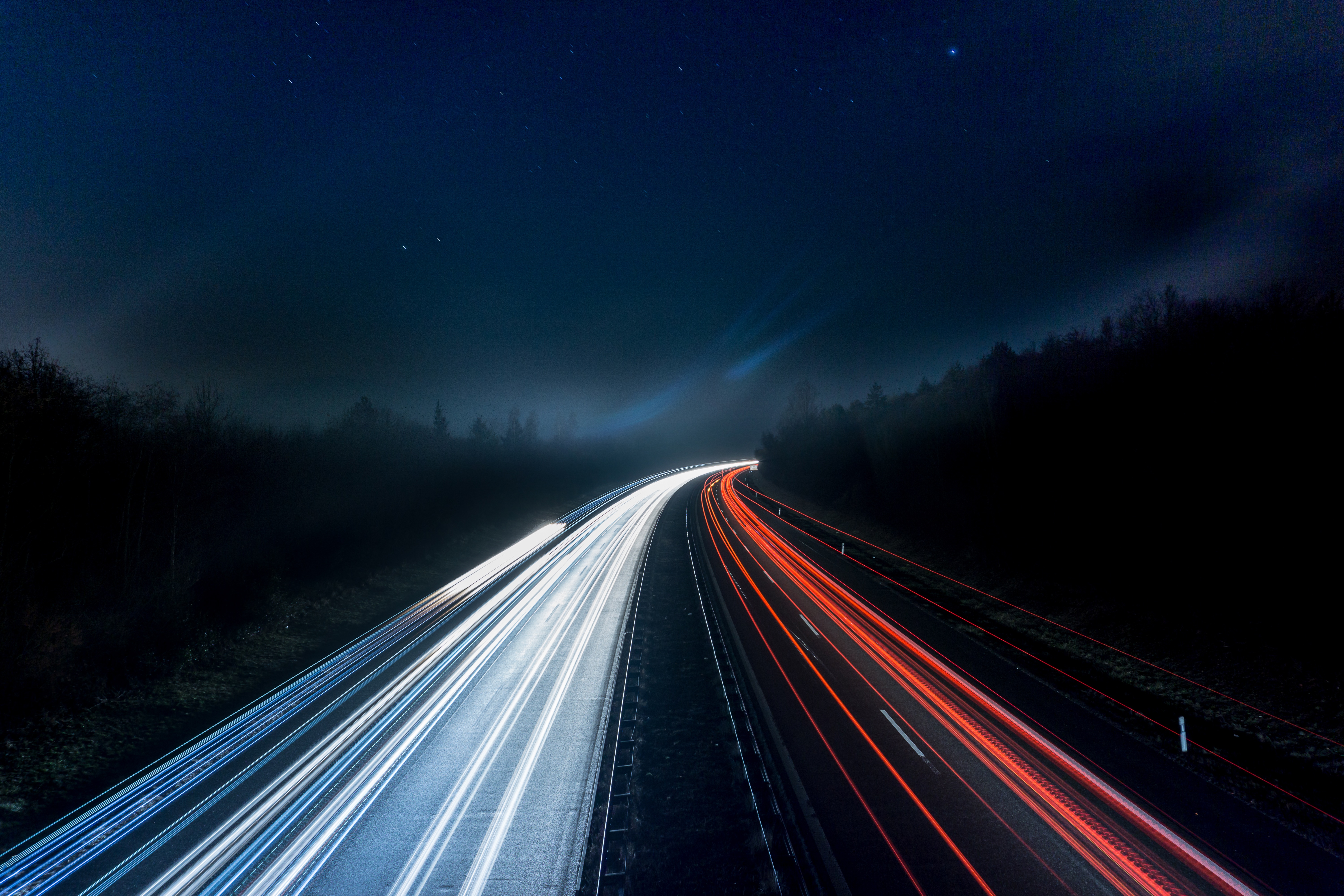 Road at nighttime showing car lights and route ahead from Drupal 7 to Drupal 9