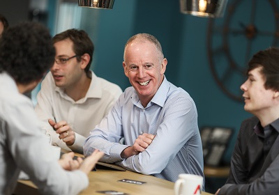 OWA team members smiling during a project meeting