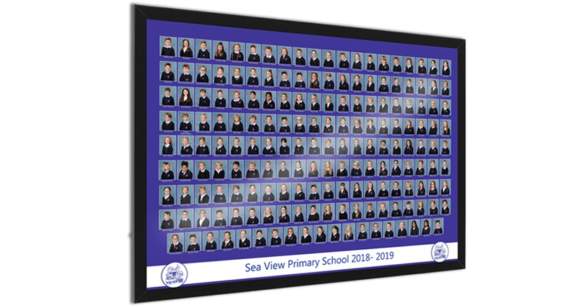 A framed photo depicting a group of individuals wearing blue clothing, smiling together in a cheerful setting.