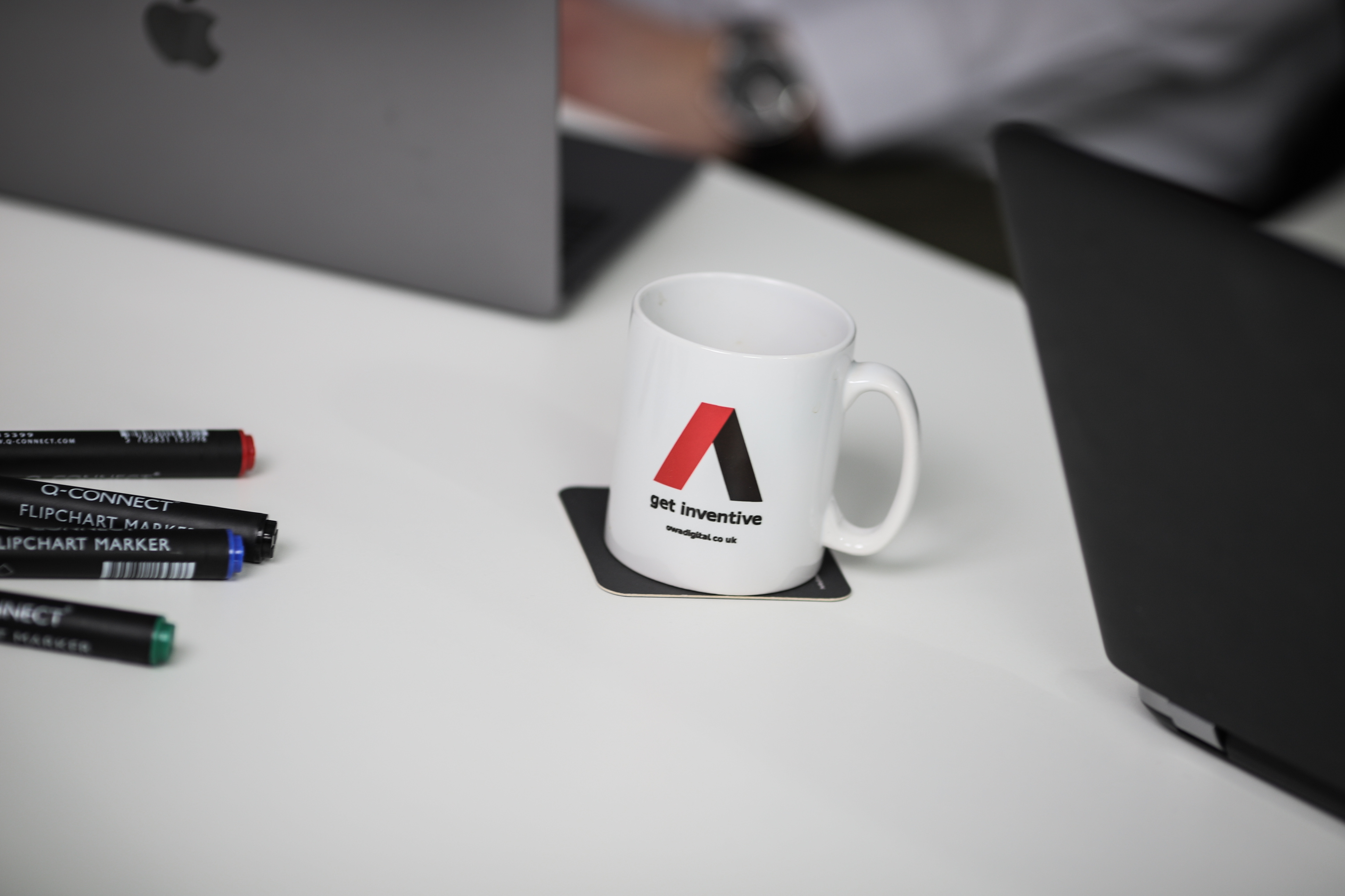 Pens and OWA cup on table ready to plan wireframing a grant management system