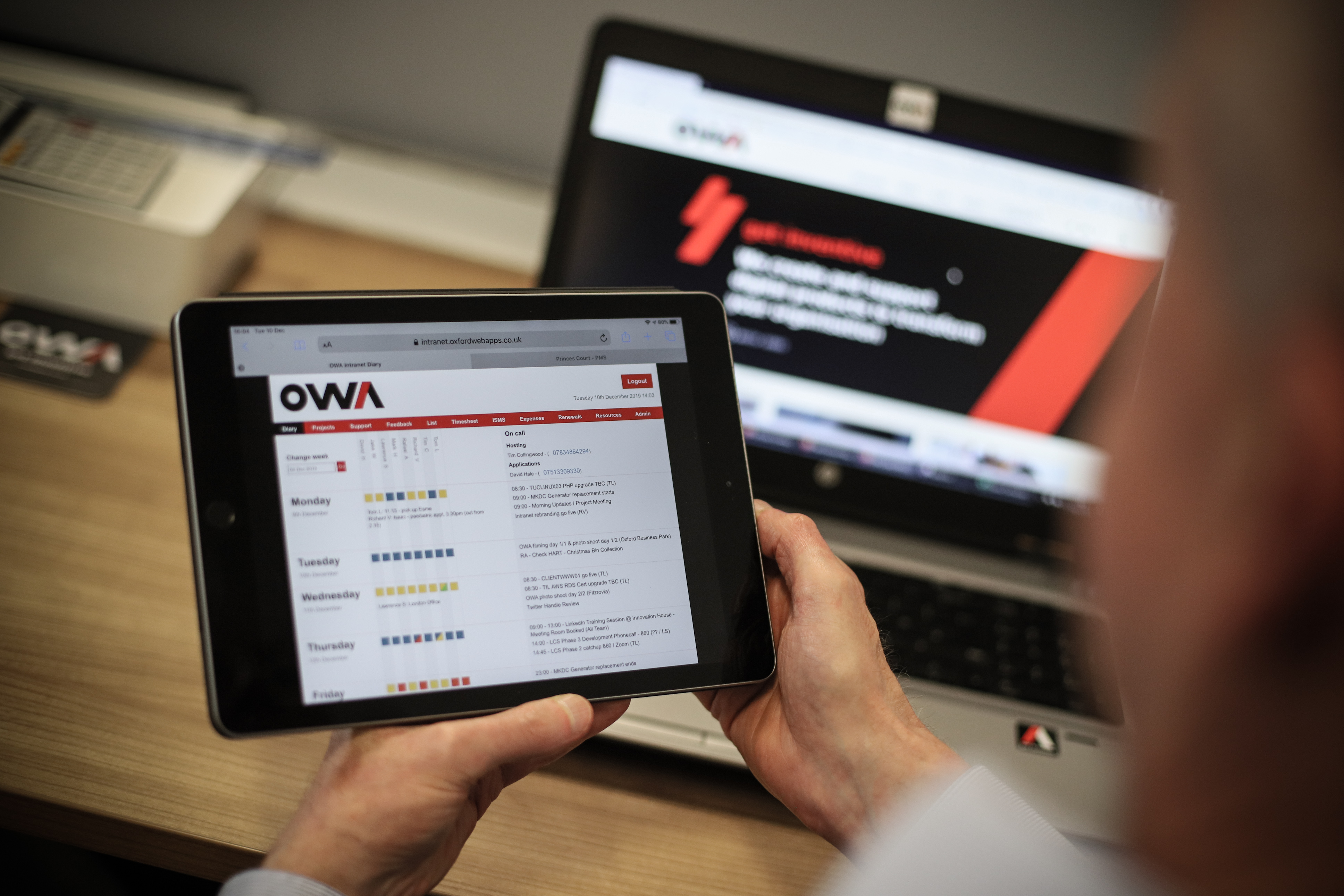 iPad showing a system in development in front of a desktop monitor