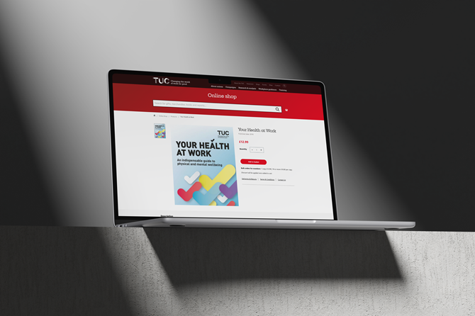 A laptop is positioned on a table, showing the TUC shop website.