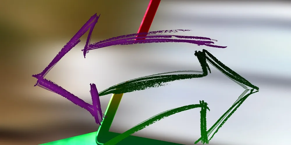 A laptop displaying a colorful arrow pointing to the screen, highlighting Website Design and Development concepts