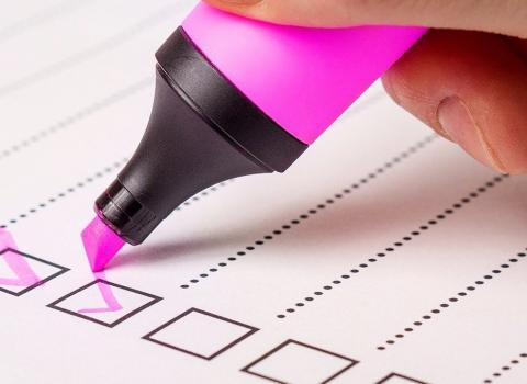 Highlighter pen ticking off items on a checklist
