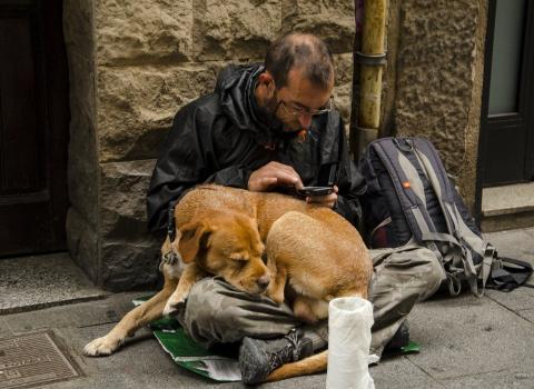 Homeless man using a smartphone