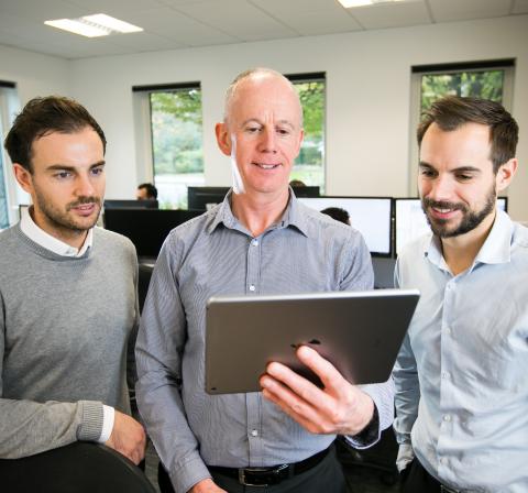 OWA team reviewing a successful website development and delivery