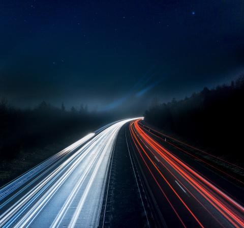 Road at nighttime showing car lights and route ahead from Drupal 7 to Drupal 9