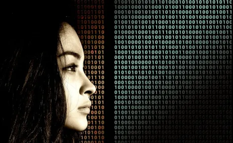 A woman examines binary code, symbolizing her role in Legacy System Support and technology analysis