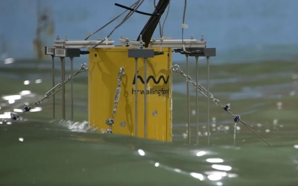 A yellow buoy floating in the water, secured by a chain attached to its base.