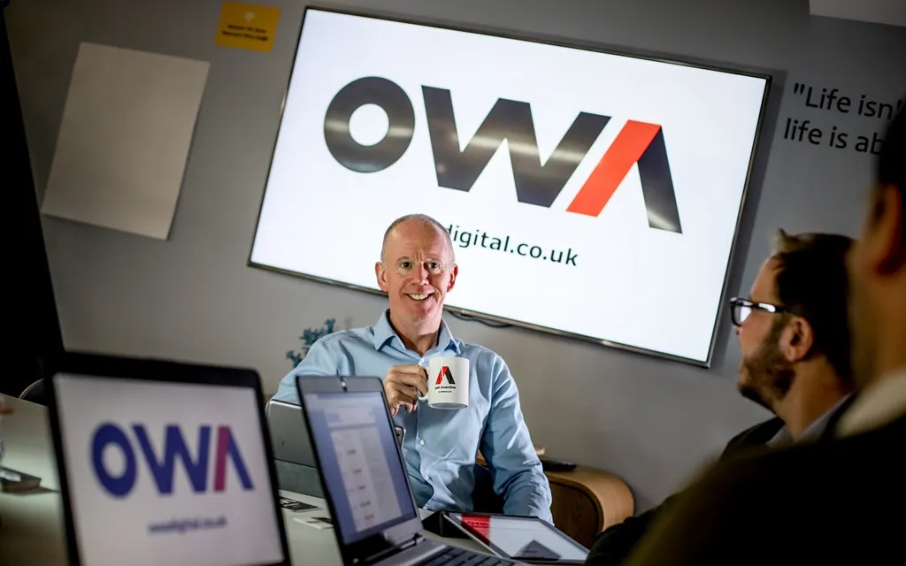 OWA team collaborating in a meeting, showcasing teamwork and leadership in a professional setting.