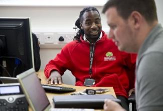 Trades Union Congress – image of two people talking to each other at work