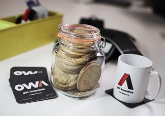 A table with tea and biscuits at an OWA project meeting